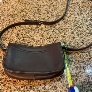 Brown leather Coach crossbody bag.
